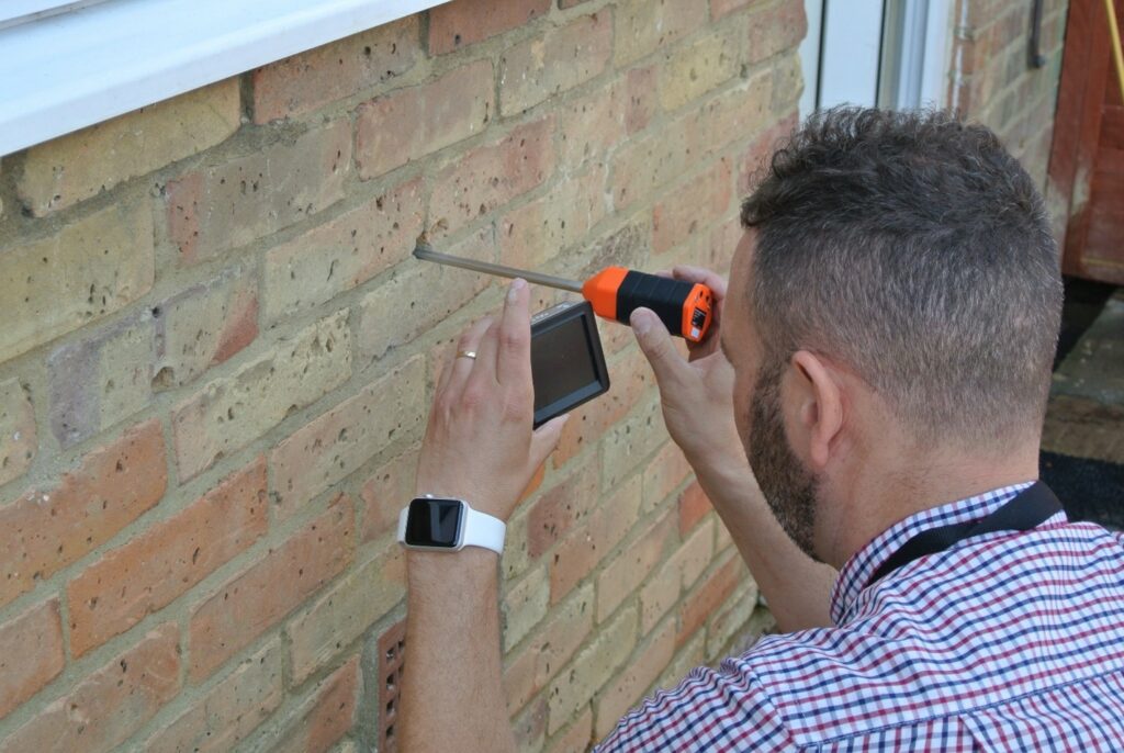 Man carrying out cavity wall insulation survey