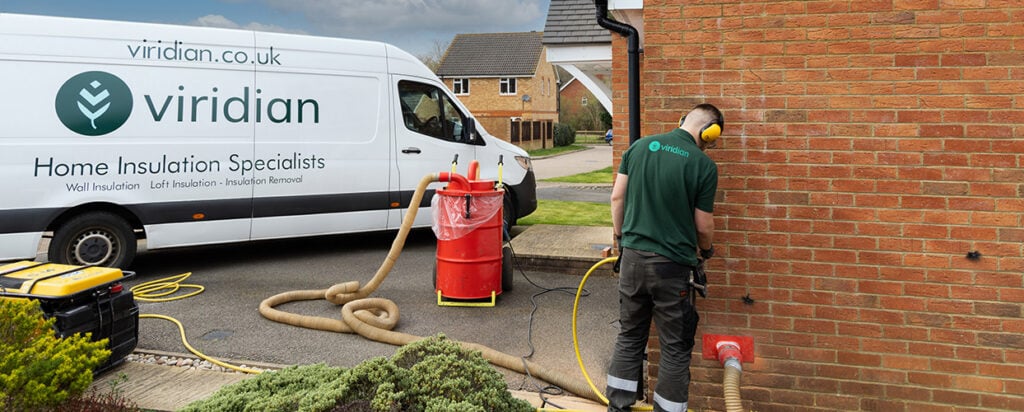 Man carrying out cavity wall insulation removal.
