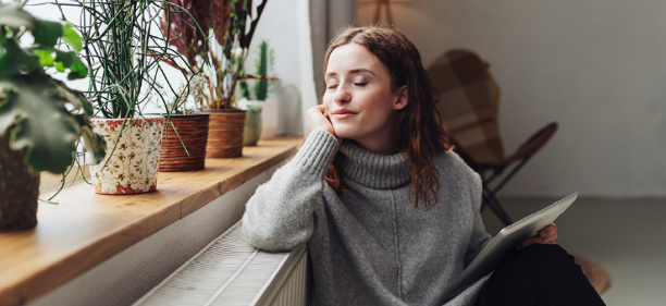 Woman sitting in the warmth of her home